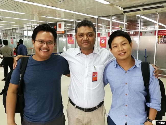Myanmar photojournalists Minzayar Oo and Hkun Lat, who were arrested in Bangladesh, are seen with their lawyer in a photo posted on Twitter, Oct. 17, 2017.