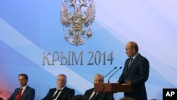 Russian President Vladimir Putin addresses Russian Duma lawmakers during a meeting in Mria sanatorium about 30 kilometers (19 miles) from Yalta, Crimea, Aug. 14, 2014. 