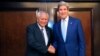 FILE - Foreign Minister of the Philippines Albert del Rosario (L) and U.S. Secretary of State John Kerry shake hands before a meeting.
