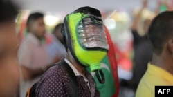 FILE - A protester wears a homemade mask for protection against potential pepper spray or teargas as thousands marched in the capital Male on June 12, 2015. Police in the Maldives unleashed pepper spray on the dozens of demonstrators, which included journalists and activists.