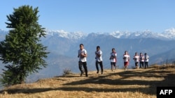 FILE - Nepali Buddhist monks running during a training session in Sindhukot village, some 80 kilometres northeast of Kathmandu, Feb. 15, 2018. (AFP PHOTO / PRAKASH MATHEMA )