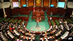 FILE - Tunisian parliament members gather during the inaugural session of the newly elected Tunisian parliament in Tunis, Tuesday, Dec. 2, 2014. 