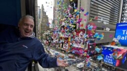 John Heald tests confetti that will be used in the New Year's celebration from a window above Times Square