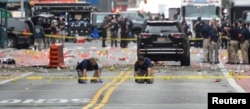 Federal Bureau of Investigation (FBI) officials mark the ground near the site of an explosion in the Chelsea neighborhood of Manhattan, New York, Sept. 18, 2016.