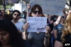 Critics of U.S. government policy which separates children their parents when they cross the border illegally from Mexico protest during a "Families Belong Together March," in downtown Los Angeles, California, June 14, 2018.