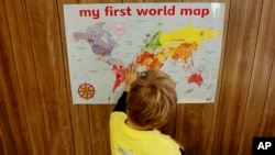 Juli Calafat, 7, from Spain, studies a world map at the Volvo Ocean Race School's temporary classroom during the offshore yacht race's three-week run in Boston, Wednesday morning, May 6, 2009. (AP Photo/Stephan Savoia)