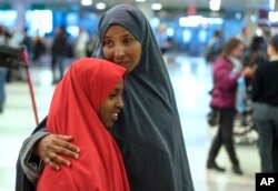 FILE - Halima Mohamed embraces her daughter in New York, March 8, 2017. Mohamed and her husband, who are from Somalia but live in the U.S., originally expected their daughters to arrive earlier this year, but the process was delayed due to the initial White House travel ban.