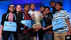 The eight co-champions of the 2019 Scripps National Spelling Bee, from left, Shruthika Padhy, Erin Howard, Rishik Gandhasri, Christopher Serrao, Saketh Sundar, Sohum Sukhatankar, Rohan Raja and Abhijay Kodali.