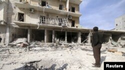 A man surveys the damage after airstrikes by pro-Syrian government forces in the rebel-held al-Sakhour neighborhood of Aleppo, Syria, Feb. 5, 2016. 