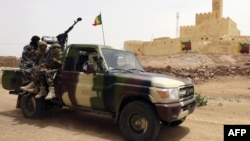 FILE - This file picture dated July 29, 2013, shows Malian soldiers patrolling in Kidal, northern Mali. 