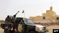 FILE - This file picture dated July 29, 2013 shows Malian soldiers patrolling in Kidal, northern Mali. 