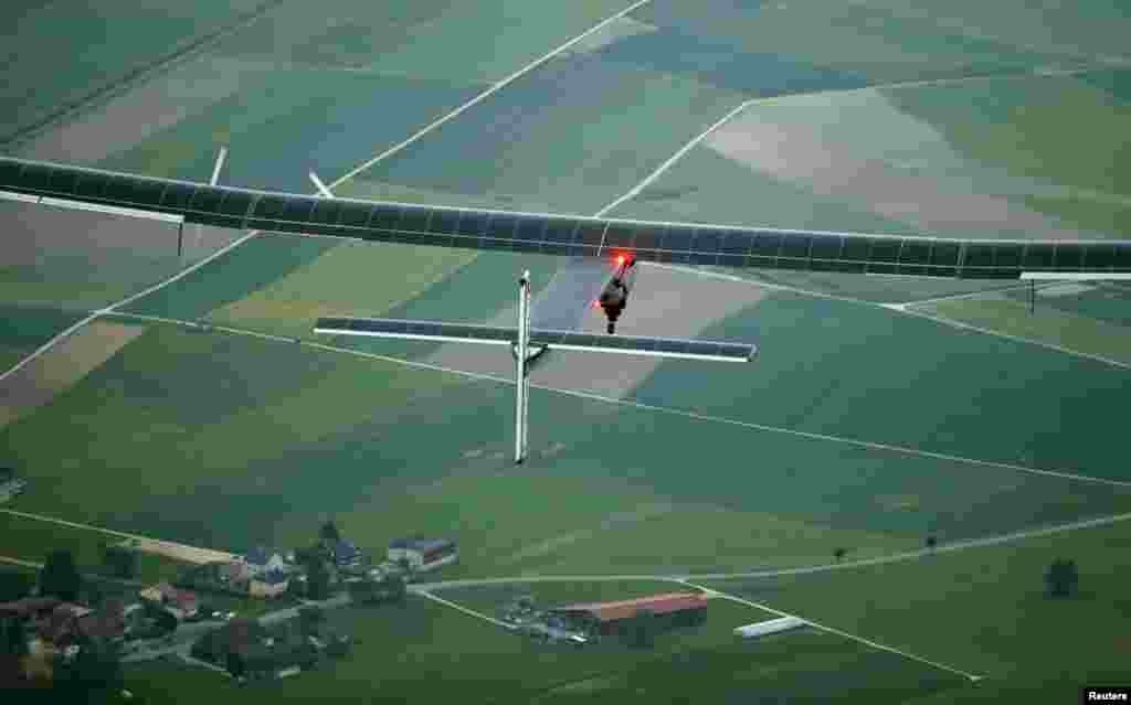 German test pilot Markus Scherdel steers the solar-powered Solar Impulse 2 aircraft druing its maiden flight at its base in Payerne, Switzerland. The aircraft weighs 2.4 tons with a wingspan of 72 meters (236 ft) and more than 17,000 solar cells.