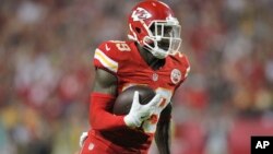 Kansas City Chiefs free safety Husain Abdullah carries the ball after intercepting a pass and running it back 39 yards for a touchdown during the fourth quarter of an NFL football game against the New England Patriots, Sept. 29, 2014.