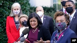 Biden Congress BudgetRep. Pramila Jayapal, D-Wash., the chair of the Congressional Progressive Caucus, center, along with other lawmakers, talks with reporters outside the West Wing, Oct. 19, 2021, following their meeting with President Biden.