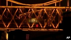 A train similar to ones seen during previous visits to China by North Korean leader Kim Jong Un crosses the Friendship Bridge from North Korea into China as seen from Dandong in northeastern China's Liaoning Province, Saturday, Feb. 23, 2019. Image taken from video.