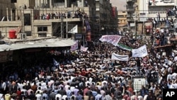 Syrians wave Islamic and revolutionary flags at a large protest in Douma, a suburb of Damascus, April 20, 2012.