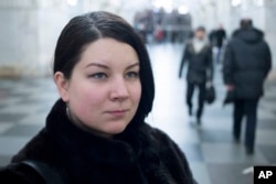 Journalist Ekaterina Vinokurova poses for a photo in the metro in Moscow, Russia, Dec. 20, 2017.