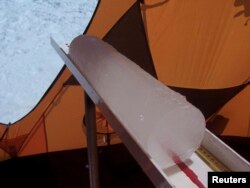 A section of ice core that researchers at the Ohio State University extracted from the Quelccaya Ice Cap in Peru is seen in a handout picture taken in 2003.