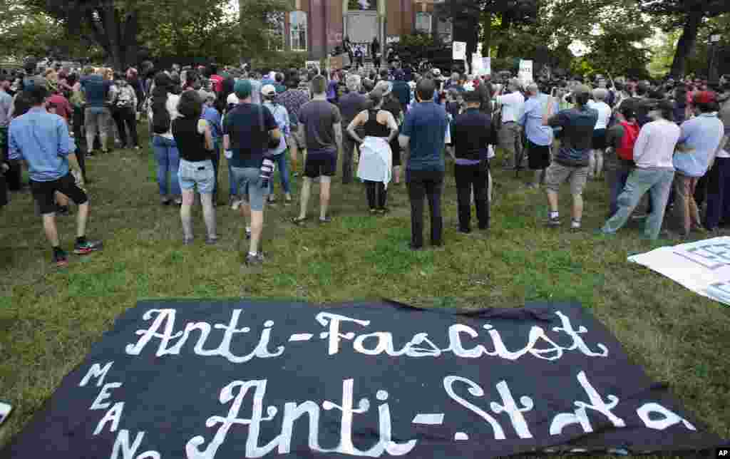 Demonstrators listen to speakers on the campus of the University of Virginia in during a rally marking the anniversary of last year's Unite the Right rally in Charlottesville, Va., Saturday, Aug. 11, 2018. 