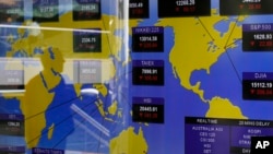 A TV screen shows the Asian stocks index at the Hong Kong Stock Exchange in Hong Kong, June 20, 2013. 