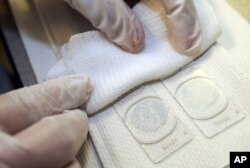 BACKGROUND - Blades are prepared at a bad and cervix screening program at the NorthPoint Health and Wellness Center in Minneapolis, Minnesota.