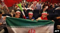 Iranians watch the World Cup Group B soccer match between Morocco and Iran at Azadi cinema in Tehran, June 15, 2018.