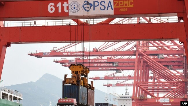 A crane loads a container onto a truck at Lianyungang Port in Lianyungang in China's eastern Jiangsu province on September 7, 2021.
