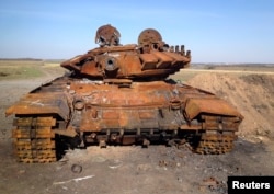 A destroyed Russian-made T-72 tank is seen on a battlefield near separatist-controlled Starobesheve, eastern Ukraine, Oct. 2, 2014.