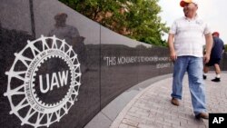 FILE - Autoworker Brent Watts walks to the United Auto Workers union hall in Spring, Hill, Tennessee.