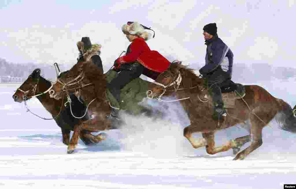 Herdsmen take part in a horse race during a local snow festival in Altay, Xinjiang Uighur Autonomous Region, China.