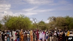 Women line up for food distribution in a makeshift camp for internally displaced people in the village of Mayen Abun, southern Sudan, May 26, 2011