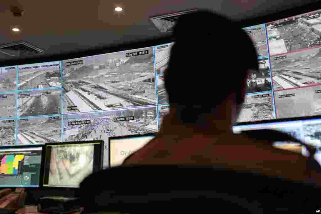 A security officer monitors Muslim pilgrims attending the annual hajj pilgrimage on CCTV screens at a security command center in Mina, Saudi Arabia, a day after a stampede killed more than 700 people.