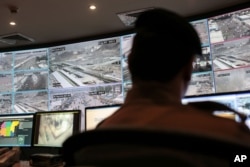 FILE - A security officer monitors Muslim pilgrims attending the annual hajj pilgrimage on CCTV screens at a security command center in Mina, Saudi Arabia, a day after a stampede killed more than 700 people, Sept. 25, 2015.
