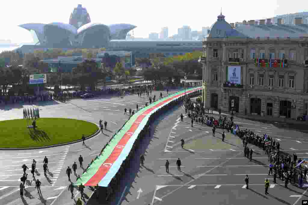 Soldiers carry a 440-meter-long (1,444-foot) Azerbaijan national flag to celebrate the Victory Day, in Baku.