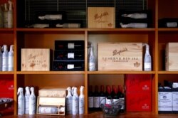 FILE - Bottles of Penfolds Grange wine and other varieties, made by wine maker Penfolds and owned by Australia's Treasury Wine Estates, at a winery located in the Hunter Valley, Australia, Feb. 14, 2018.
