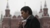 A man smokes along a street in central Moscow October 16, 2012. 