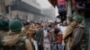 Indian policemen stop protesters at a police barricade in New Delhi, India, Dec. 20, 2019.