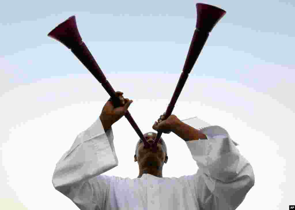 A Qatari soccer fan blows a vuvuzela before the announcement of the hosts for the 2022 World Cup, in Souq Waqif December 2. (Fadi Al-Assaad/Reuters)