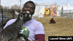 This April 10, 2020 photo shows Marshall Mitchell, Urban Farm Assistant at the Urban Growers Collective farm in Chicago. The nonprofit teaches young kids and others to grow vegetables at eight urban farms around the city. (Laurell Sims via AP)