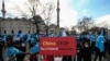 A protester from the Uyghur community living in Turkey, holds an anti-China placard during a protest in Istanbul, March 25, against the visit of China's FM Wang Yi to Turkey. 