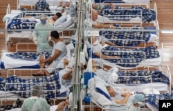 COVID-19 patients lie on beds in a field hospital built inside a gym in Santo Andre, on the outskirts of Sao Paulo, Brazil, June 9, 2020.