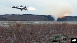 FILE - Caught at the moment of main motor ignition, a Javelin self-guided missile streaks towards it's target during maneuvers in Alaska, US.