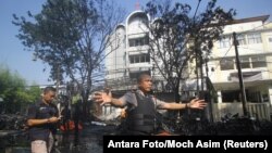 Police stand guard near the site of a blast at the Pentecost Church Central Surabaya, in Surabaya, East Java, Indonesia, May 13, 2018.