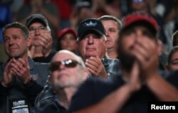 FILE - Members applaud as U.S. President Donald Trump addresses the National Rifle Association's (NRA) 148th annual meeting in Indianapolis, Indiana, April 26, 2019.