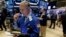 Trader Timothy Nick, left, works on the floor of the New York Stock Exchange, March 8, 2016. 