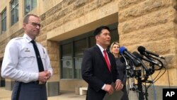 FILE - From left to right, Prince George’s County Police Chief Henry Stawinski, U.S. Attorney Robert Hur, of the District of Maryland, and Jennifer Moore, Baltimore special agent, address reporters April 9, 2019, outside the federal courthouse in Greenbelt, Mary