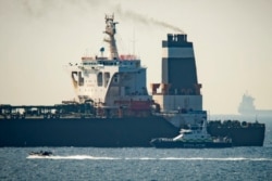 A Royal Marine patrol vessel is seen beside the intercepted Grace 1 super tanker in the British territory of Gibraltar, July 4, 2019.