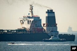 A Royal Marine patrol vessel is seen beside the intercepted Grace 1 super tanker in the British territory of Gibraltar, July 4, 2019.