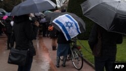 FILE - People take part in a slient march in Strasbourg, France, March 28, 2018, in memory of an 85-year-old Jewish woman murdered in her home in what police believe was an anti-Semitic attack.