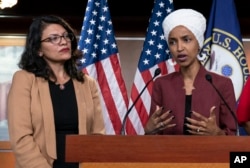 FILE - U.S. Representatives Rashida Tlaib, left, and Ilhan Omar participate in a news conference in Washington, July 15, 2019. In 2018, the two became the first Muslim women elected to U.S. Congress; they are credited for igniting a wave of Muslim political activism.